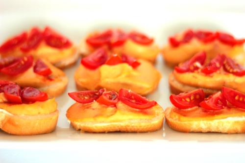 Red Pepper Hummus Topped with Baby Plum Tomato Wedges